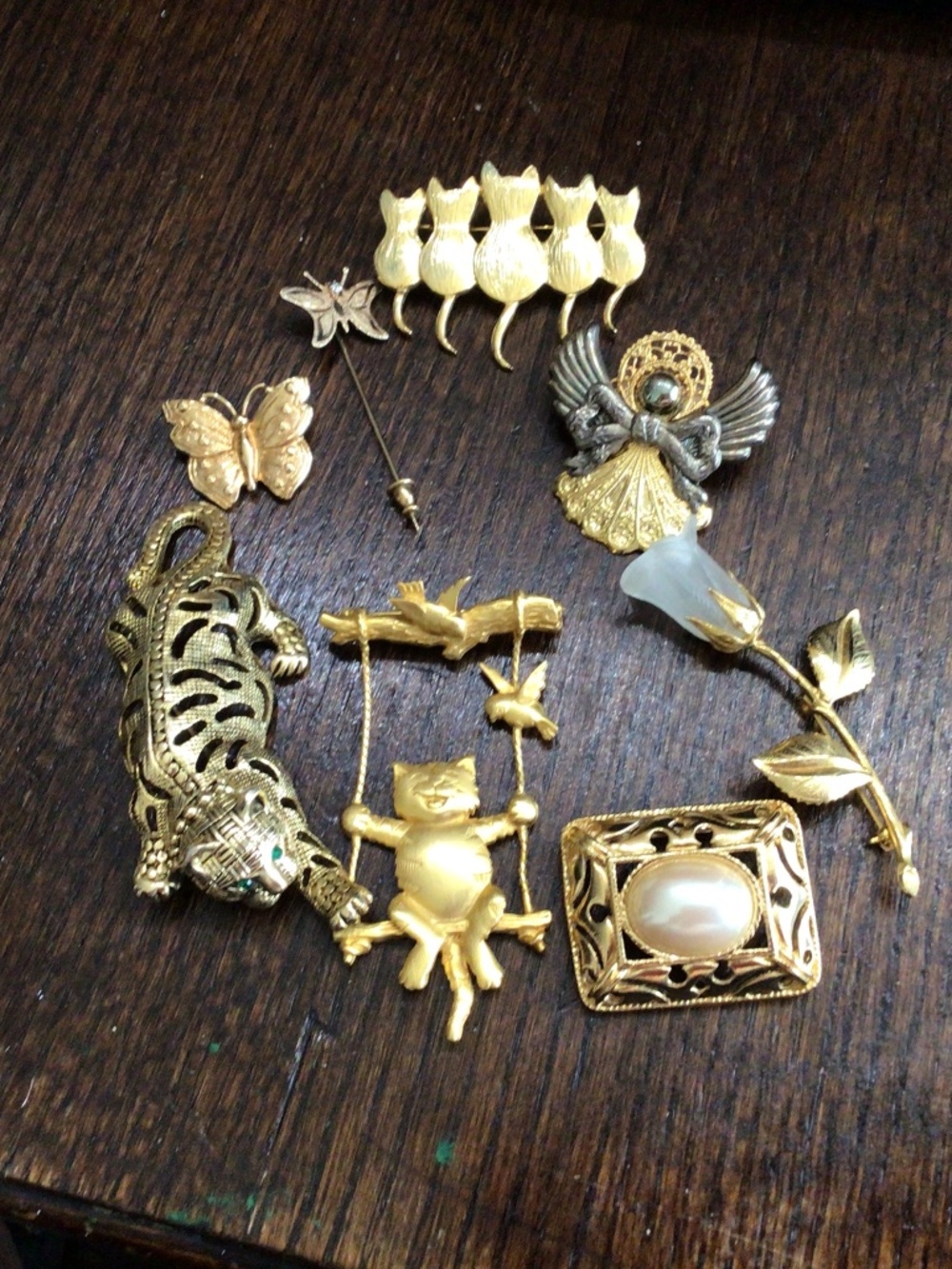 Lot of 8 miscellaneous gold-tone brooches & 1 stick pin.  3 are signed.